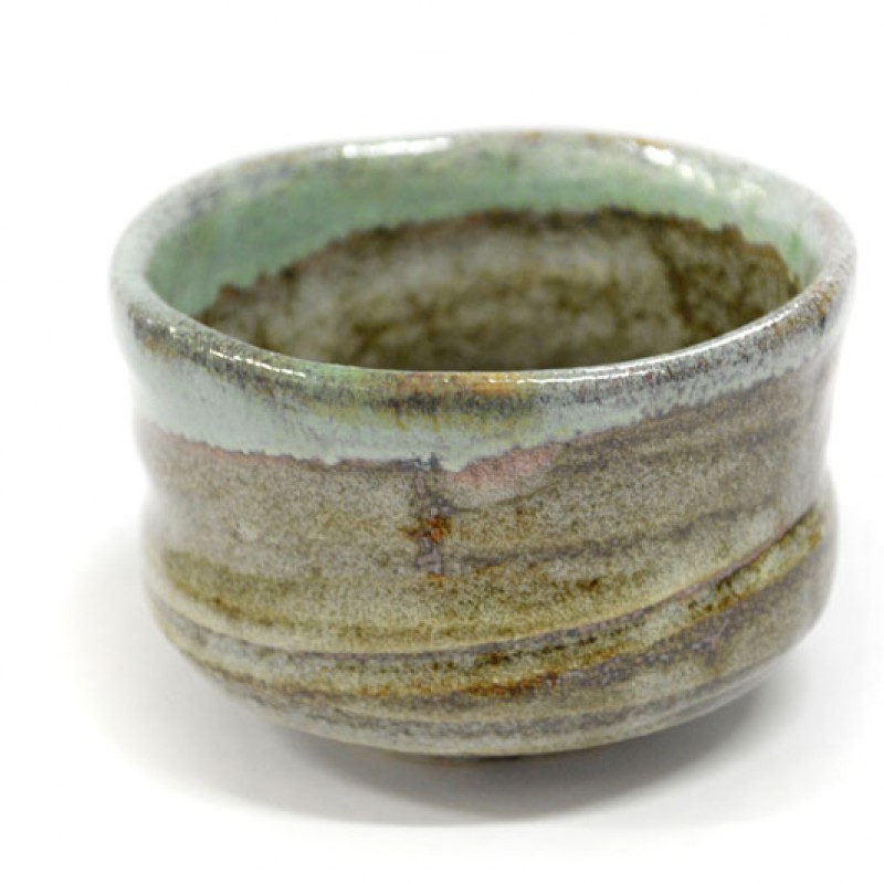 Natural leather mouse pad on white desk next to porcelain mug and keyboard.